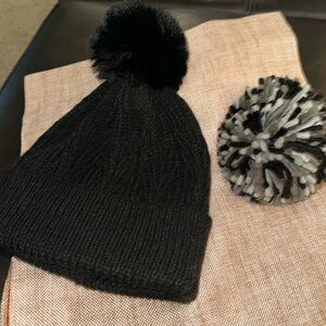 Two hats in one! Snap off and on the Pom poms!